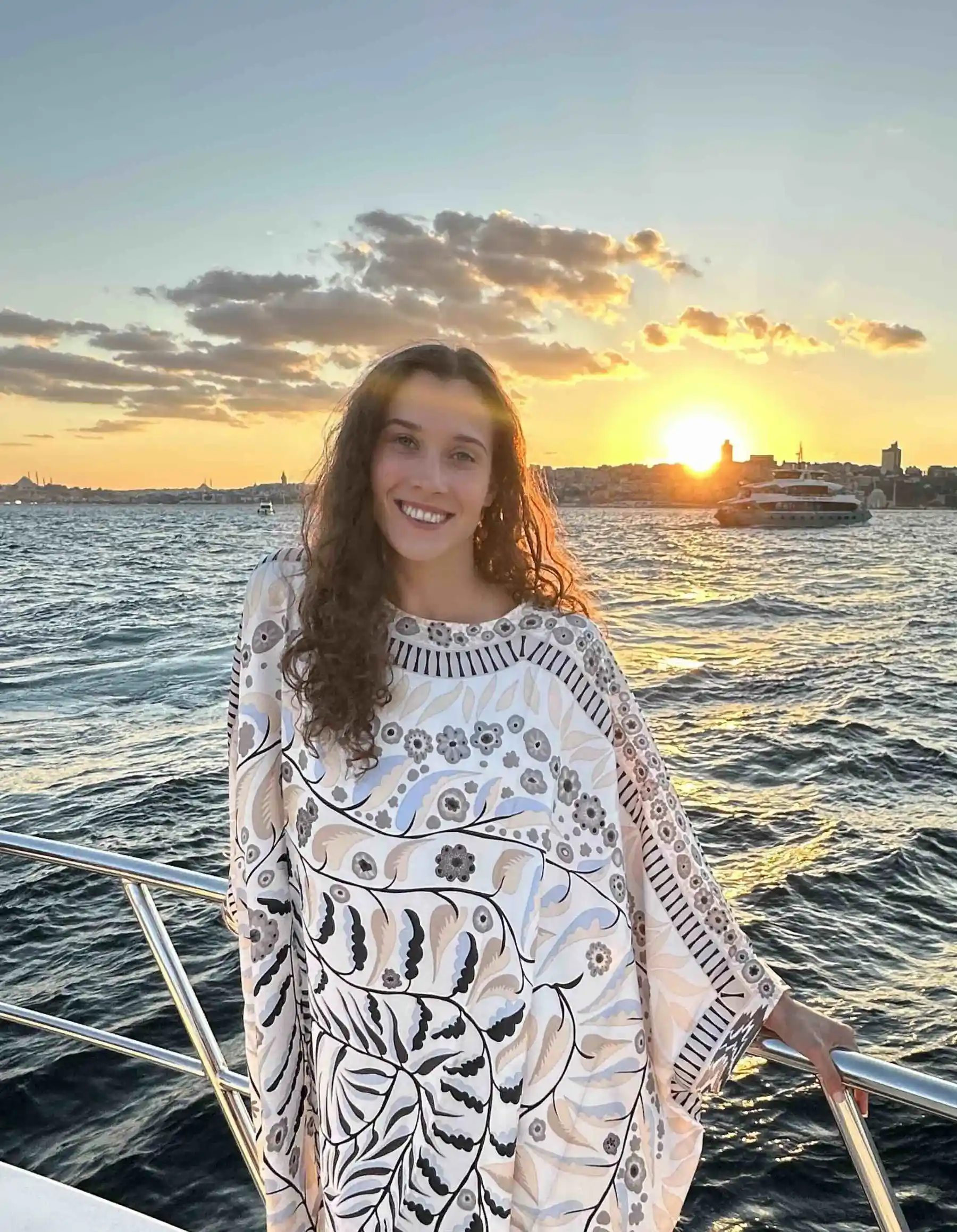 Greer standing infront of a sunset